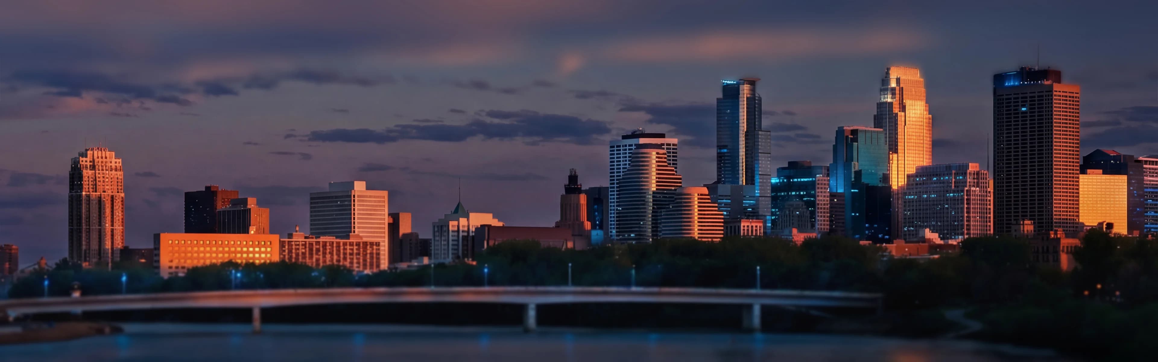 Minneapolis skyline with river and modern buildings - managed Wi-Fi, fiber internet, and bulk TV services for Minneapolis multifamily properties
